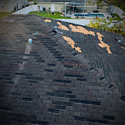 Roof with damaged shingles.