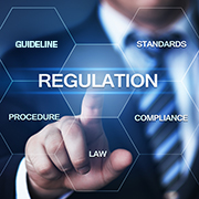 A hand points at 'Regulation' among compliance terms.