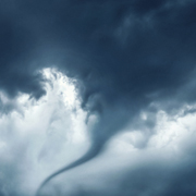 A tornado swirls through a dark sky