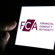 Finger pointing at screen displaying FCA logo.