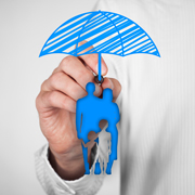 Person's hand holding drawing of umbrella over illustration of family.