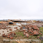 Bricks and other debris cover a yard where a house was destroyed by an April 2026 tornado in Union Center, Wisconsin.