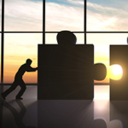 Large Puzzle pieces being pushed by a man