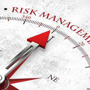 Photo of a compass with risk management written in red