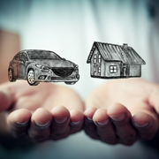 Hands holding images of a car and a house