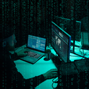 Computer in a dark room, tinged blue in light