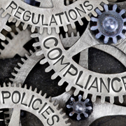Regulations, compliance and policies stamped on interconnecting gears