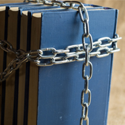 Chains wrapped around books to close them