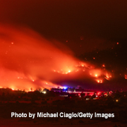 Wildfire flames and smoke from the Aspen Acres wildfire light up the night sky in Colorado