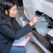 An insurance adjuster inspecting a car