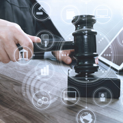 Image of judge's hand with gavel surrounded by technology and court icons.
