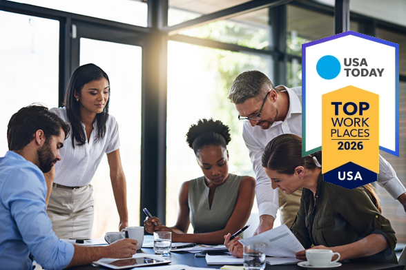 Diverse Team Members Looking at Table with award icon