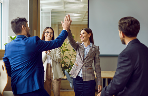 Business team members giving high five