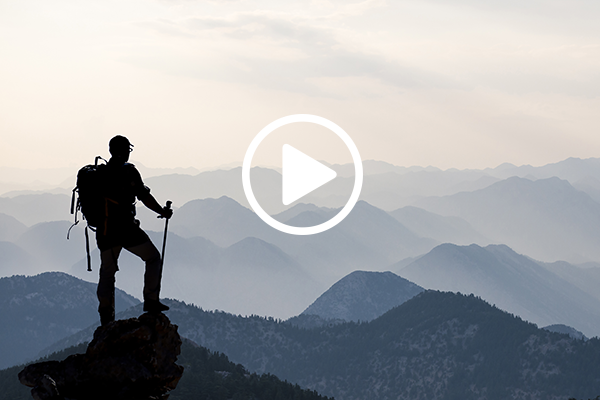 Man on Mountain with video play icon