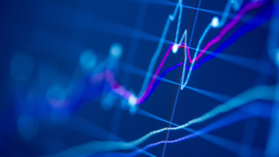 Pointing to laptop with graphs and charts