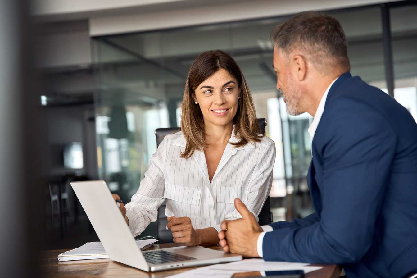 Man and Woman talking over laptop