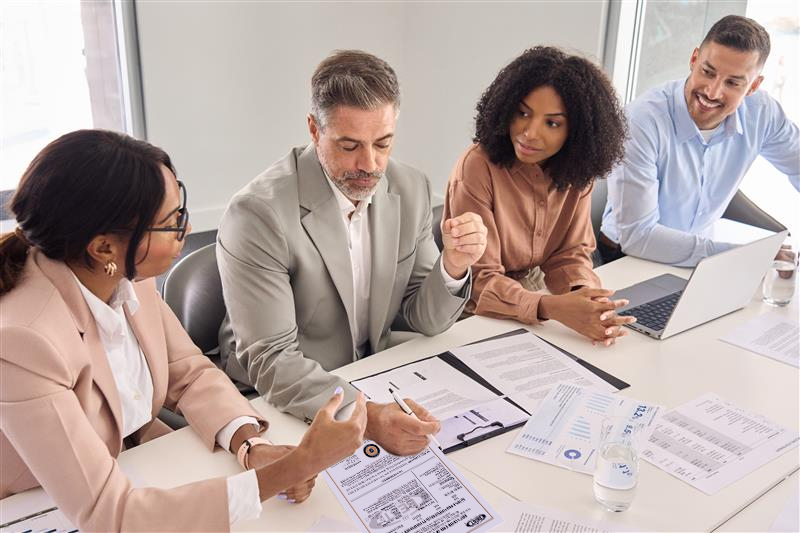 People in meeting looking at chart