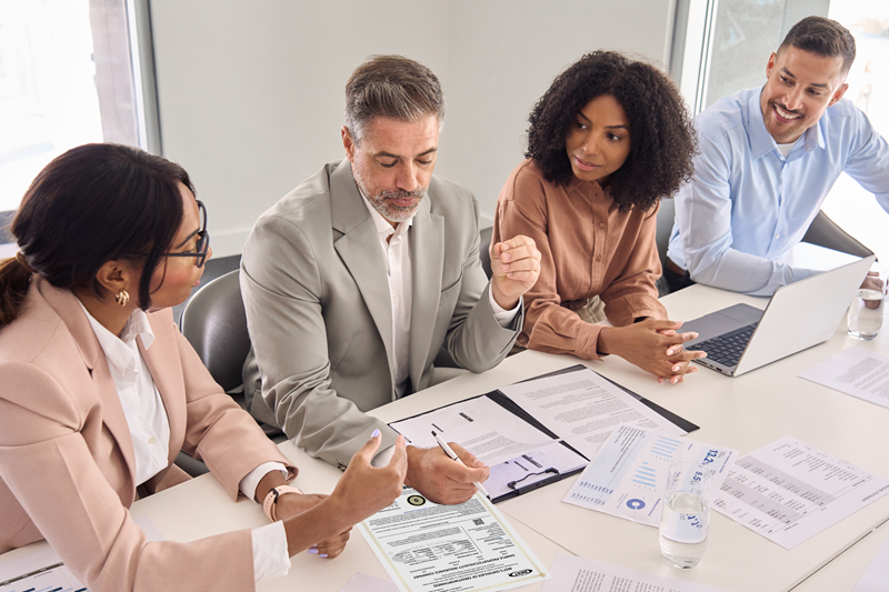 People in meeting looking at chart