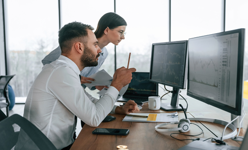 Man and Woman Looking at Computer