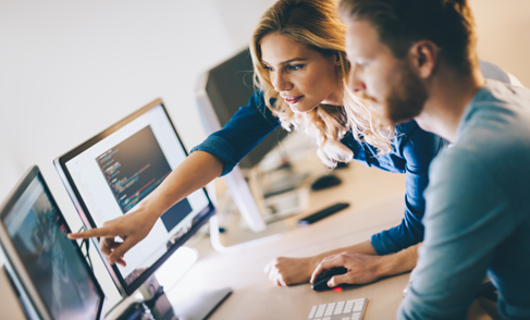 Man and Woman Pointing at Computer